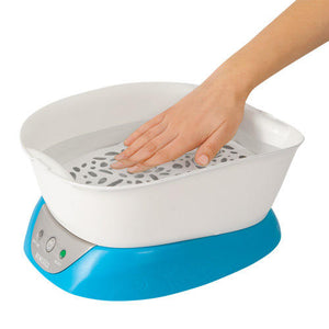 Hand inside the Homedics ParaSpa Plus Paraffin Bath