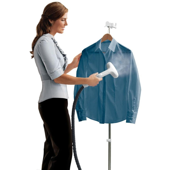 Woman steams dress shirt on hanger with theHomedics HOME Touch Perfect Steam Deluxe Commercial Garment Steamer
