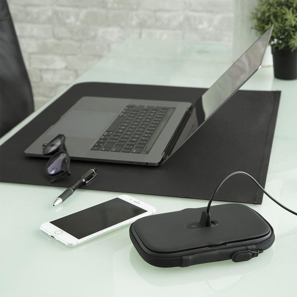 Black | Black Homedics UV CLEAN Portable Phone Sanitizer charging next to laptop on computer desk