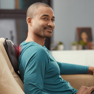 Man sitting in chair enjoys back massage from the Homedics Cordless Shiatsu Massage Pillow with Heat