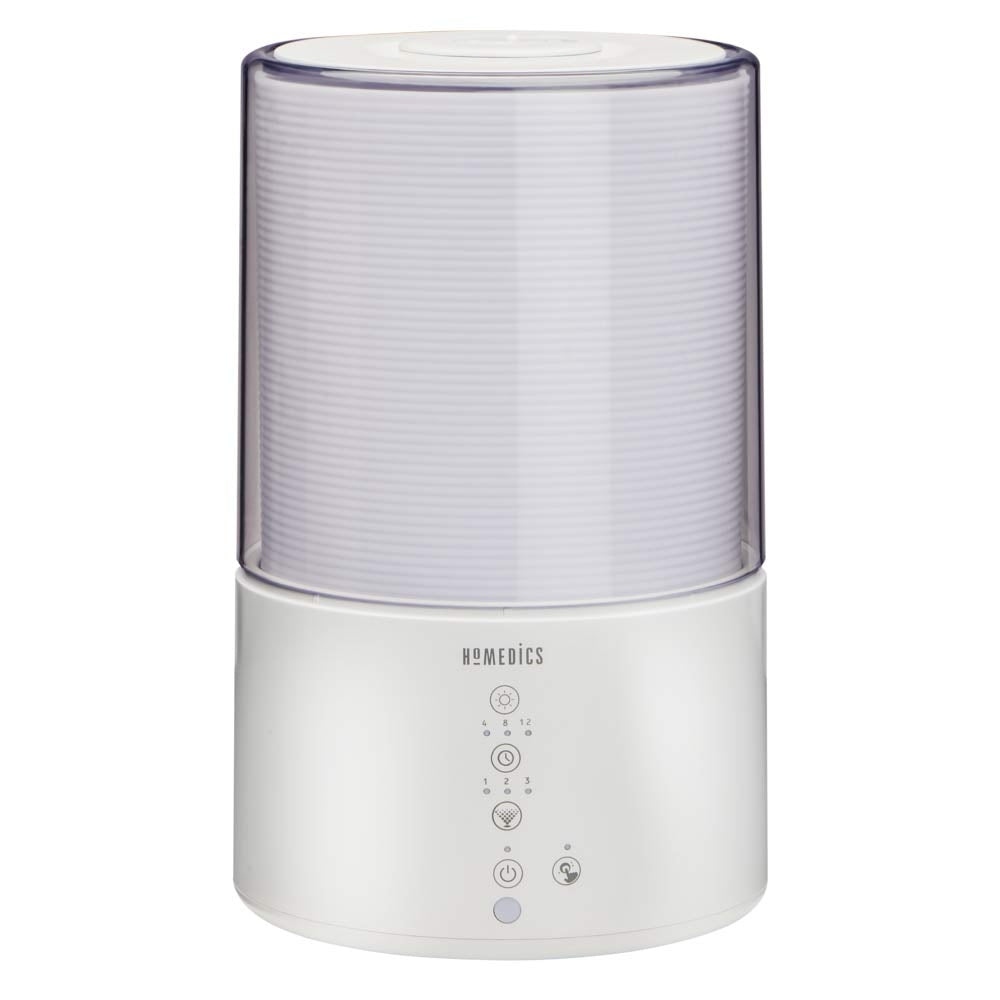Dog sits up on couch next to a powered Homedics TotalComfort Cool-Mist Humidifier on table