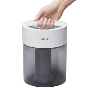 Hand holds the carry handle on the Homedics TotalComfort Ultrasonic Cool Mist Humidifier