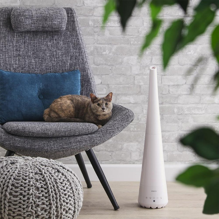 Homedics TotalComfort 2-in-1 Humidifier with mist extension wand on floor next to chair