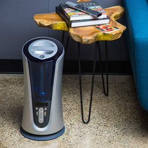 Homedics TotalComfort Humidifier Deluxe on floor next to end table