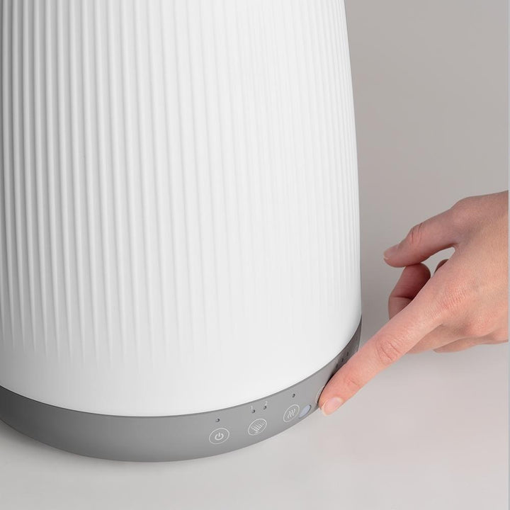 Close-up of hand on controls for the Homedics TotalComfort Ultrasonic Humidifier